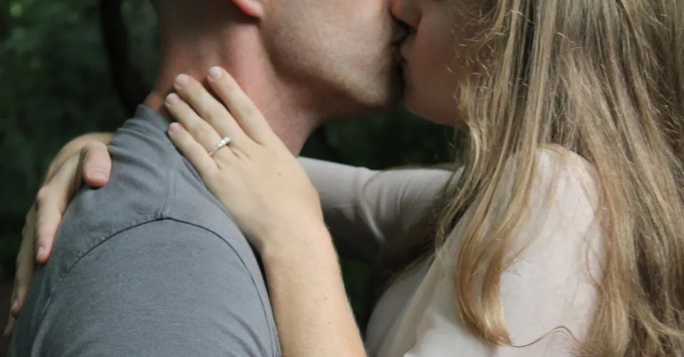 People kissing in a park