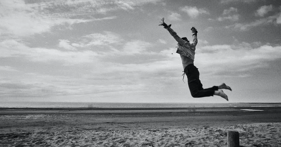 Man being bold on a beach