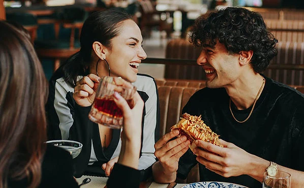 He's using emotional contagion seduction to get her to laugh with him