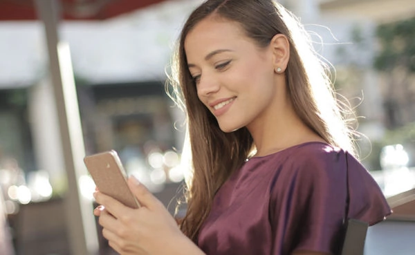 A beautiful woman in a cafe using the top Providence dating apps