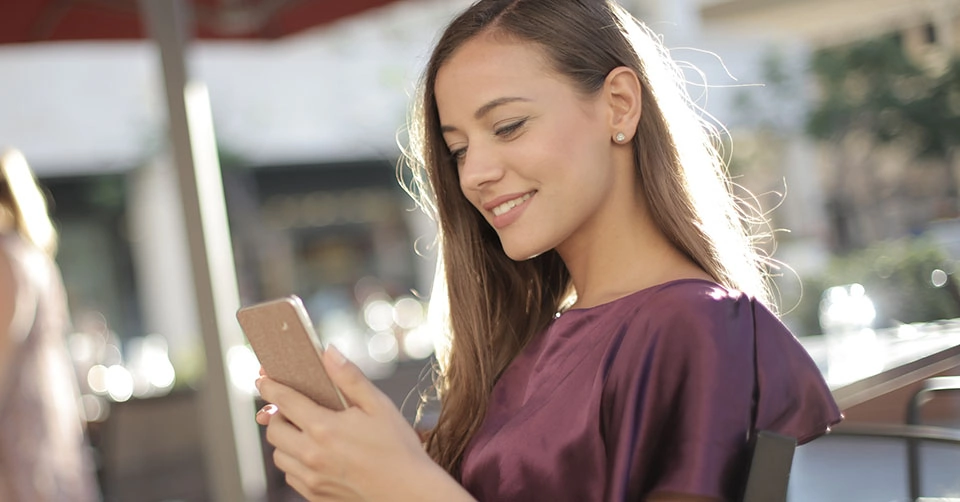 A beautiful woman in a cafe using the top Providence dating apps