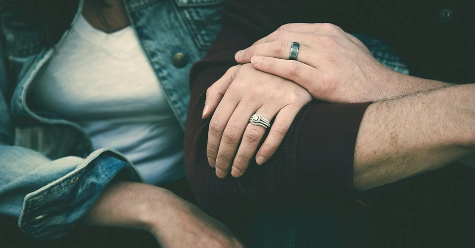 A couple showing off their rings