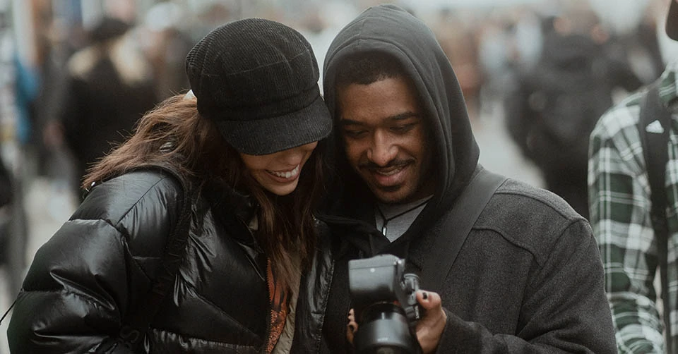 A couple taking photos in the city