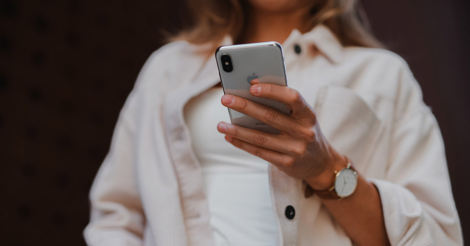 A well-dressed woman texting