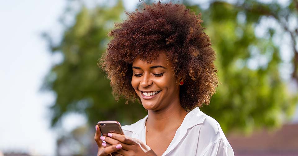 A woman in a white blouse using a Newport News dating app