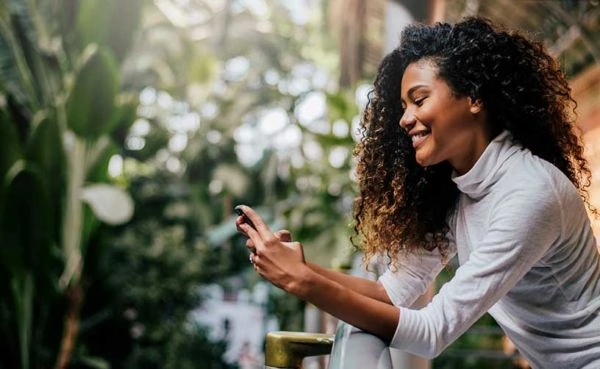 A woman smiling as she matches with someone on a Montgomery dating app