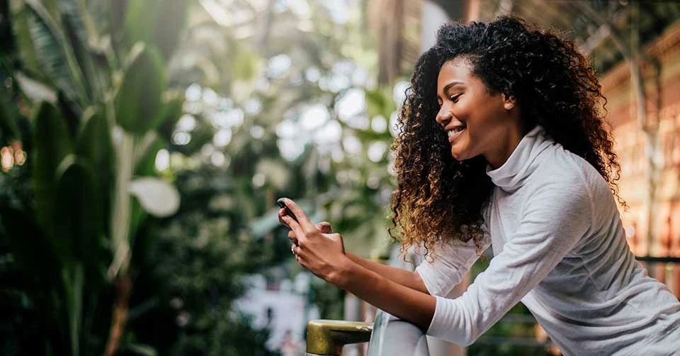 A woman smiling as she matches with someone on a Montgomery dating app