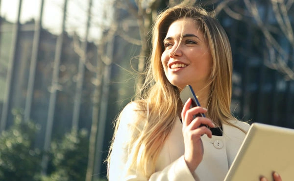 A woman in a park looking for a date in an Akron dating app