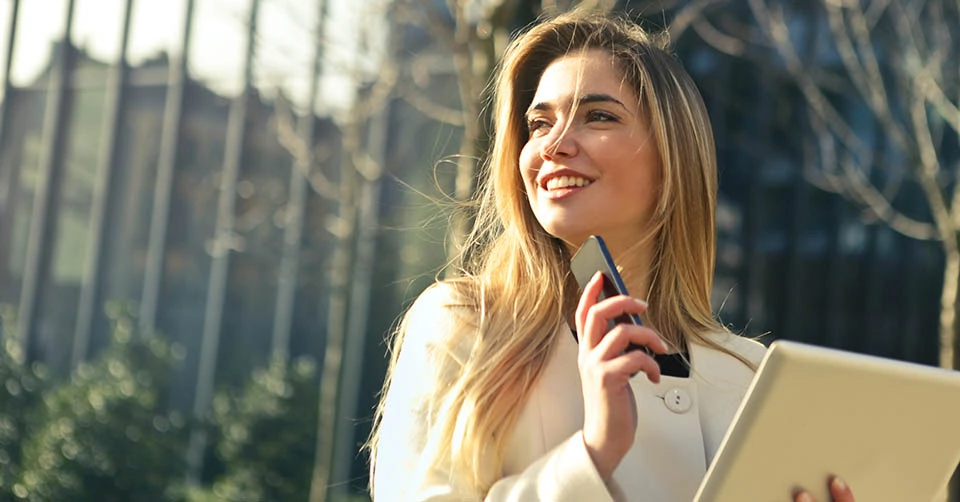 A woman in a park looking for a date in an Akron dating app