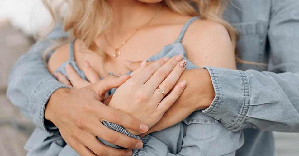 Engaged couple hugging