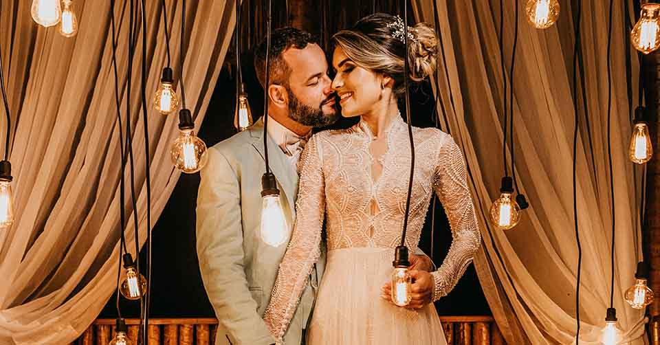 Married couple posing with lightbulbs