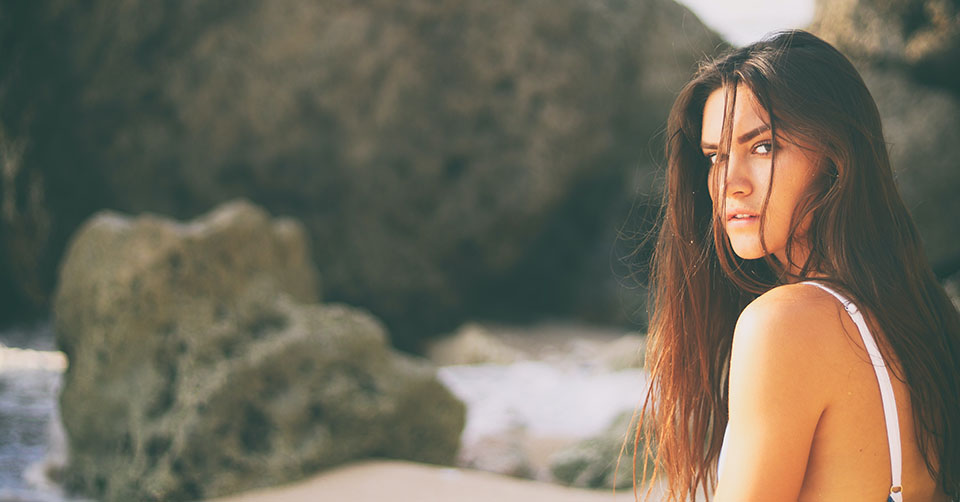 A beautiful woman on a rocky beach