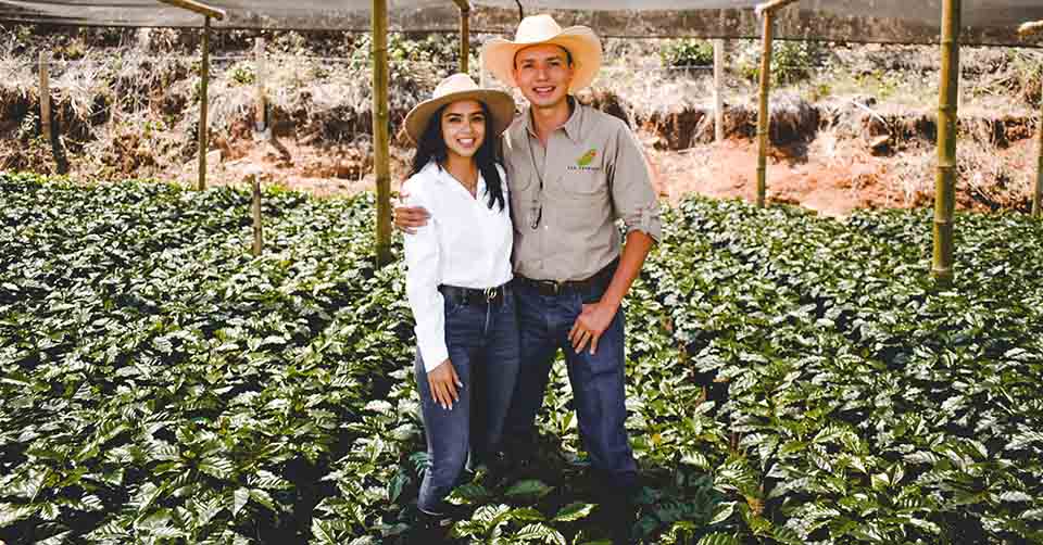 A happy couple in their greenhouse