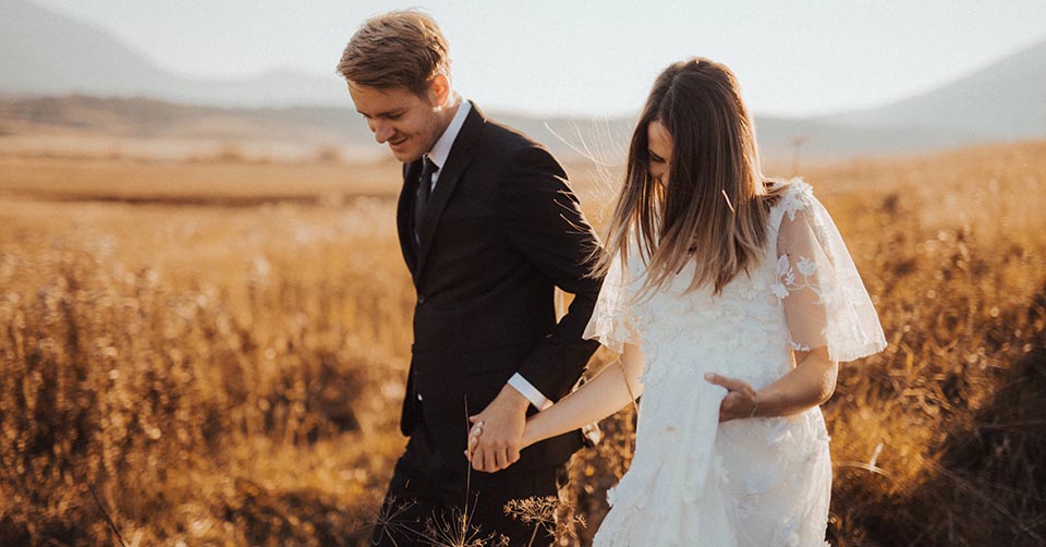 Newly married couple in a field