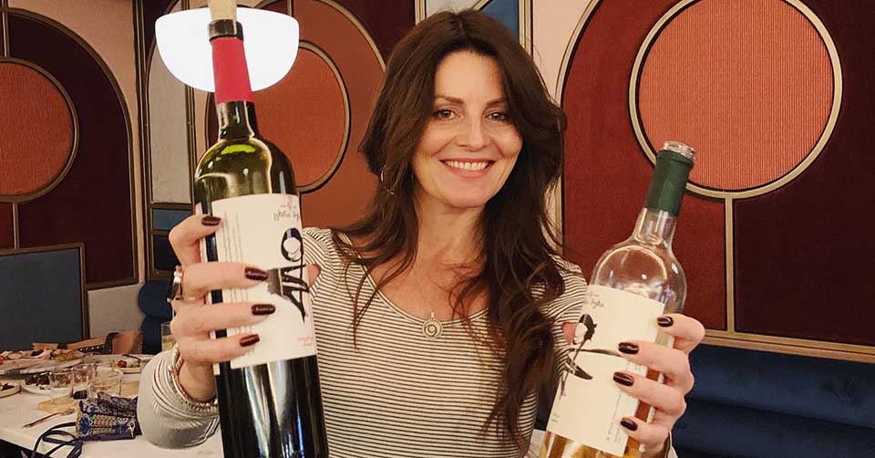 Beautiful woman holding wine bottles from The Market