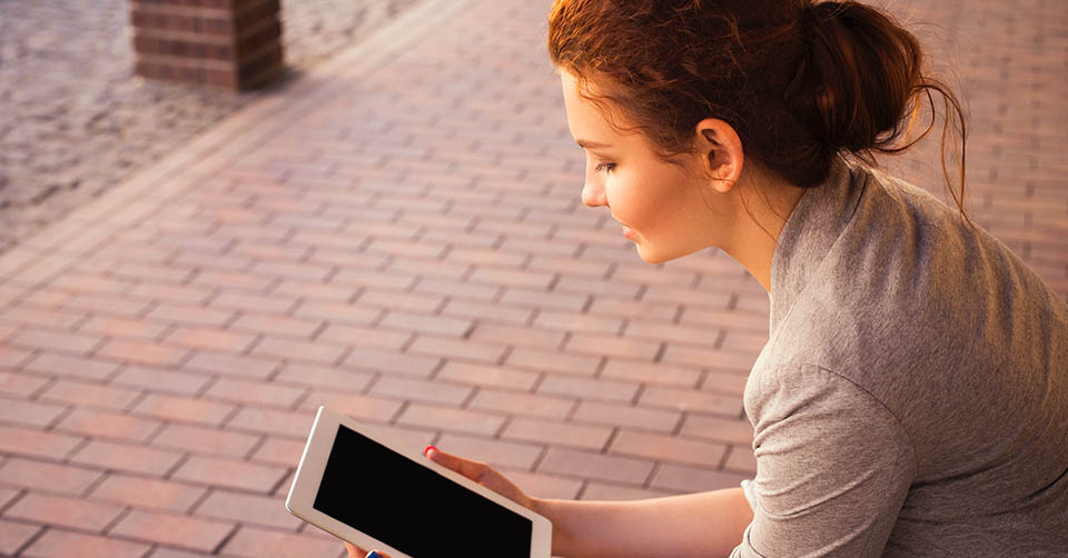 Using a dating app on her tablet