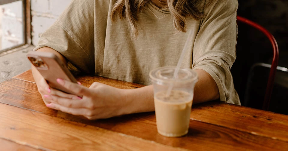 Using a dating app while on her coffee break