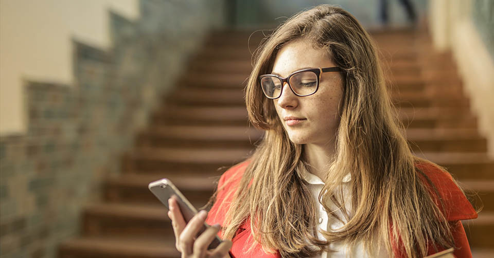 A student using her favorite dating app on campus