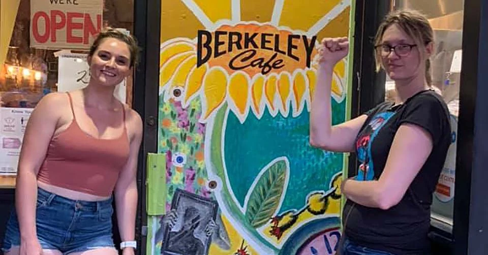 Friends painting a mural at Berkeley Cafe Raleigh