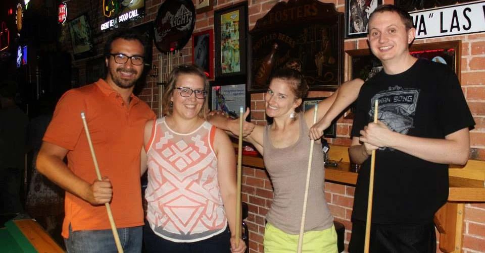 Friends playing billiards at Tony's Bar Colorado Springs