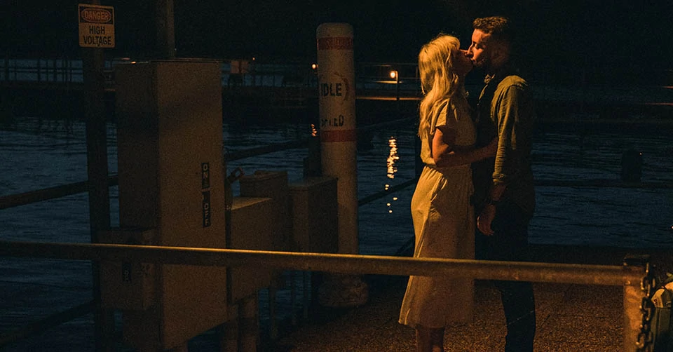 A couple kissing under a streetlight