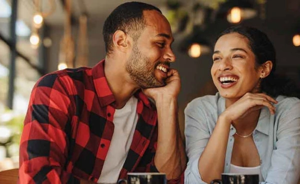 An attractive couple dating in Memphis in a coffee shop