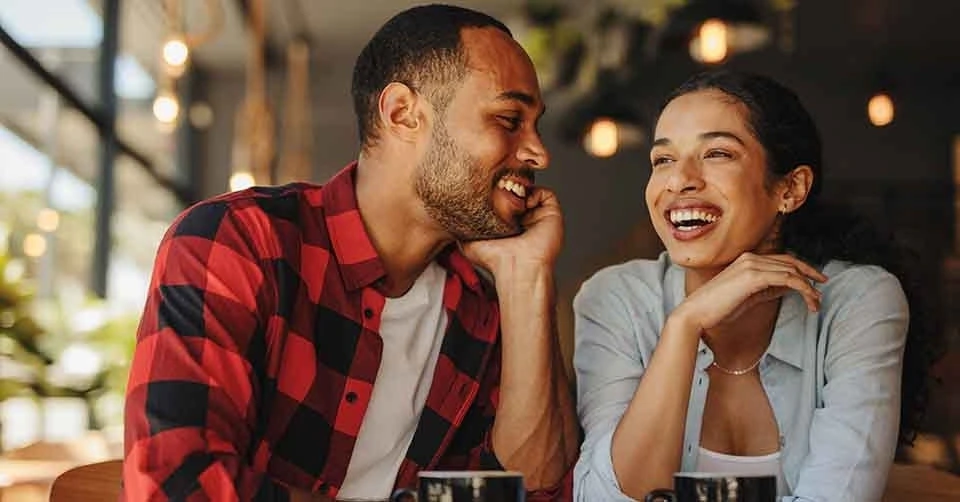 An attractive couple dating in Memphis in a coffee shop