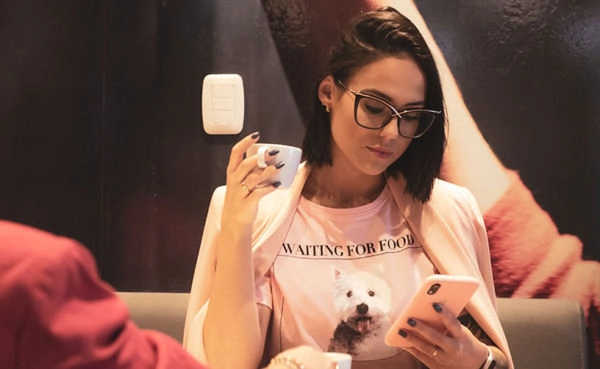 A woman with glasses using a Victoria dating app