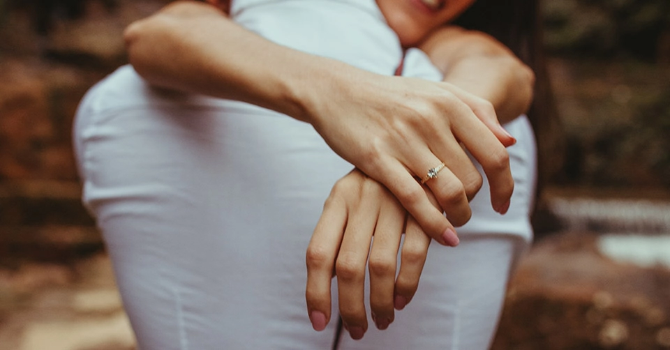 Hugging while wearing her engagement ring