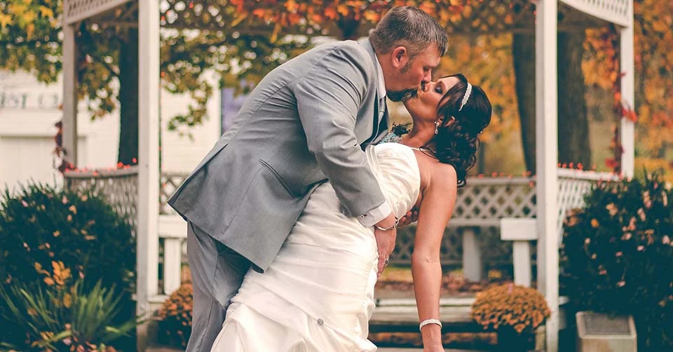 Newlyweds in front of a gazebo