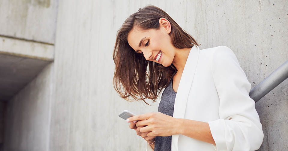 A woman being entertained by some funny Bumble prompt answers