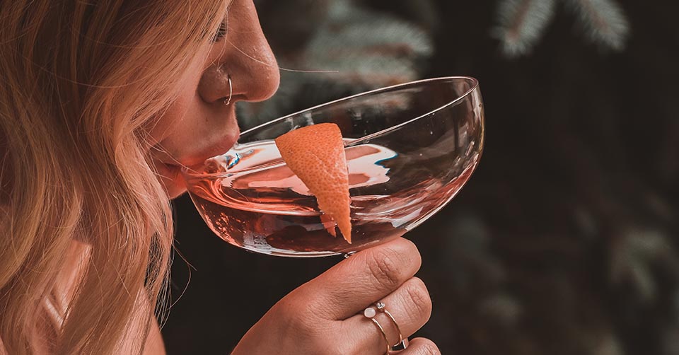 Woman sipping a cocktail