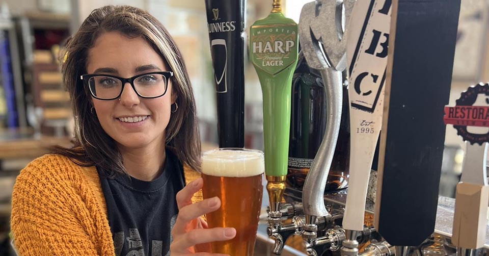 A beautiful woman choosing the right beer at The Vault Wine Bar Arlington Texas