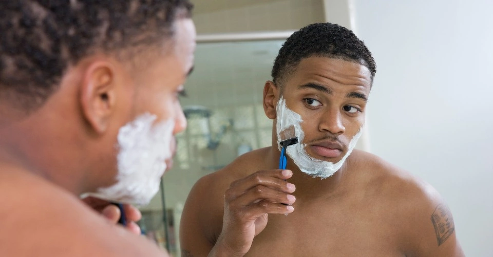 A man shaving his beard