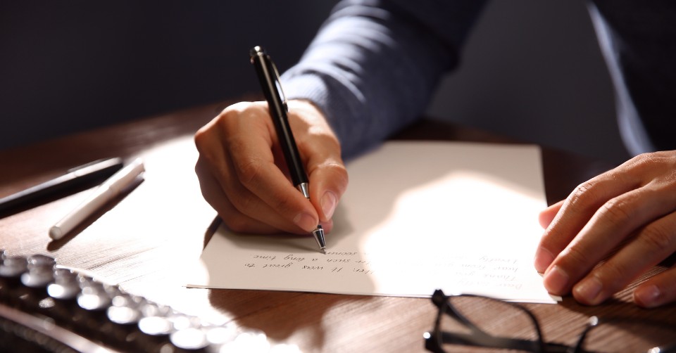 Writing a love letter for his girlfriend