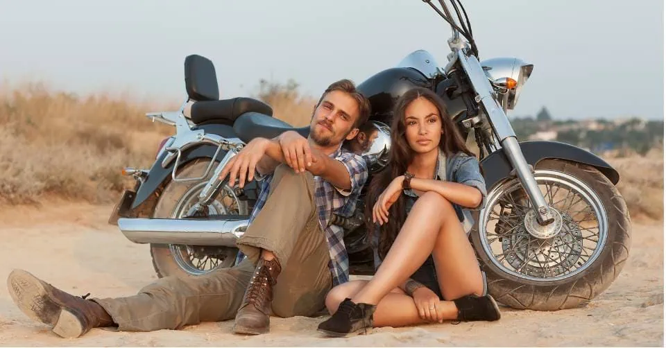 A biker couple at the beach