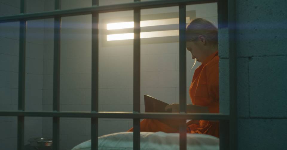 An inmate reading a book